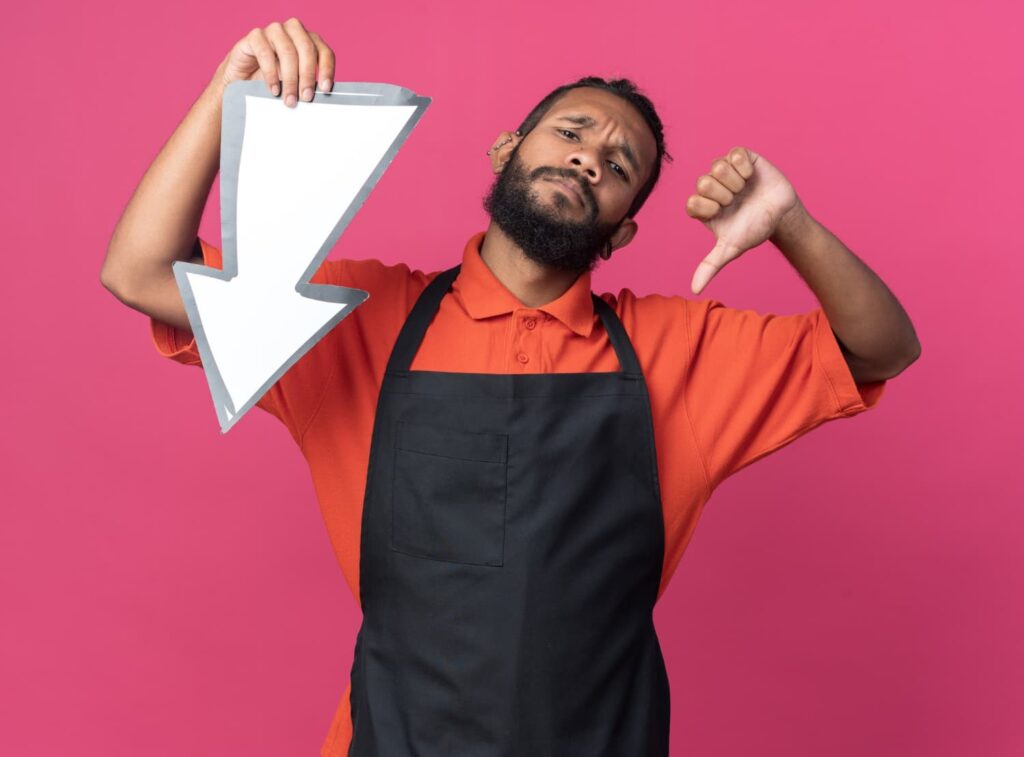 man holding a downward arrow and frowning (1)